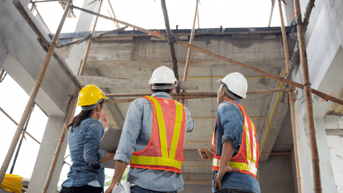 Contractors on the field checking the structure&nbsp;