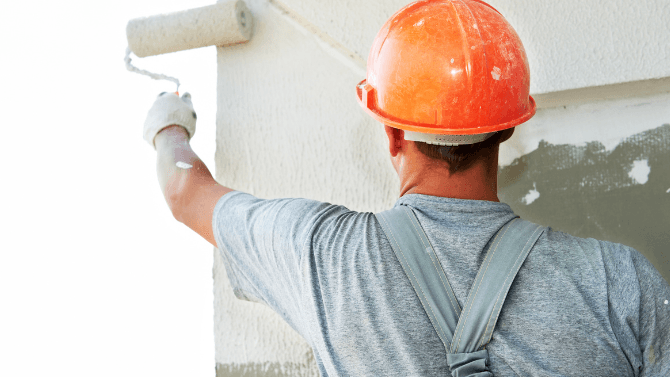 Painter painting a white wall