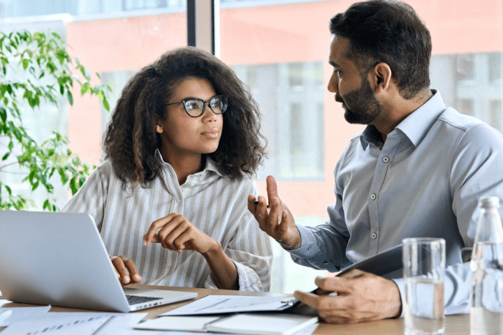 two person talking in front of a computer&nbsp;