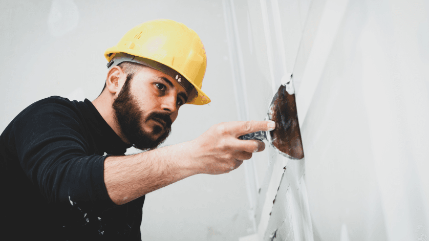 Contractor repairing gypsum wall