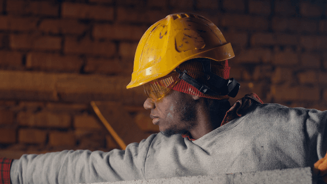 Contractor removing a brick wall