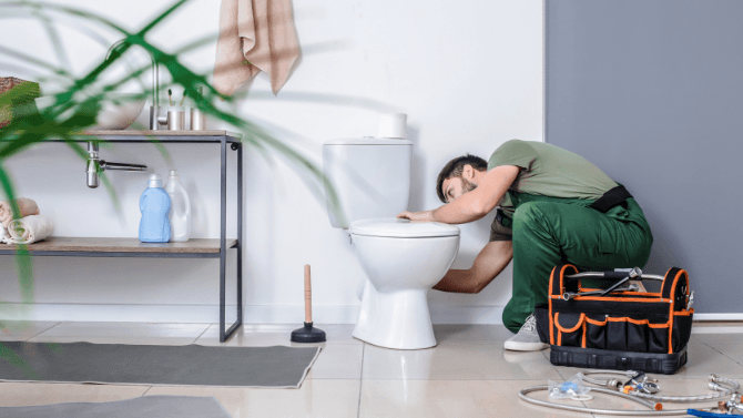 Contractor installing a toilet