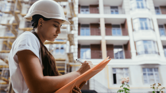 woman on the field taking notes