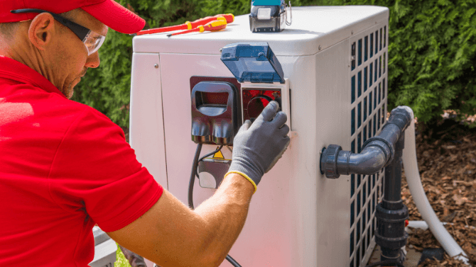 Technician installing a heating system for the pool