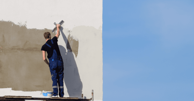 man painting exterior wall