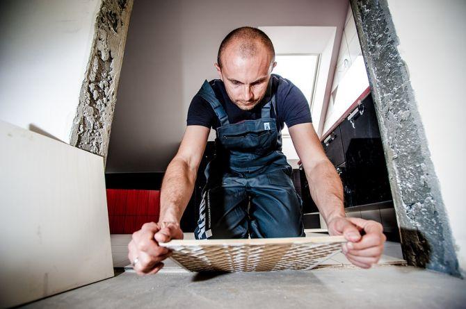 Man placing ceramic tile