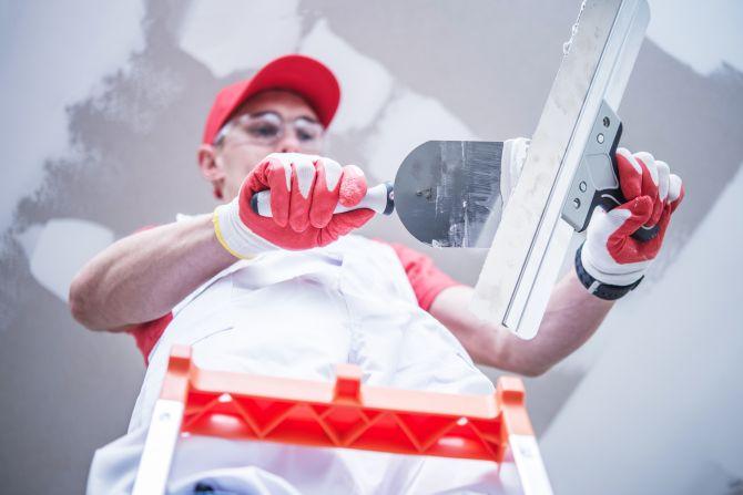 man finishing drywall