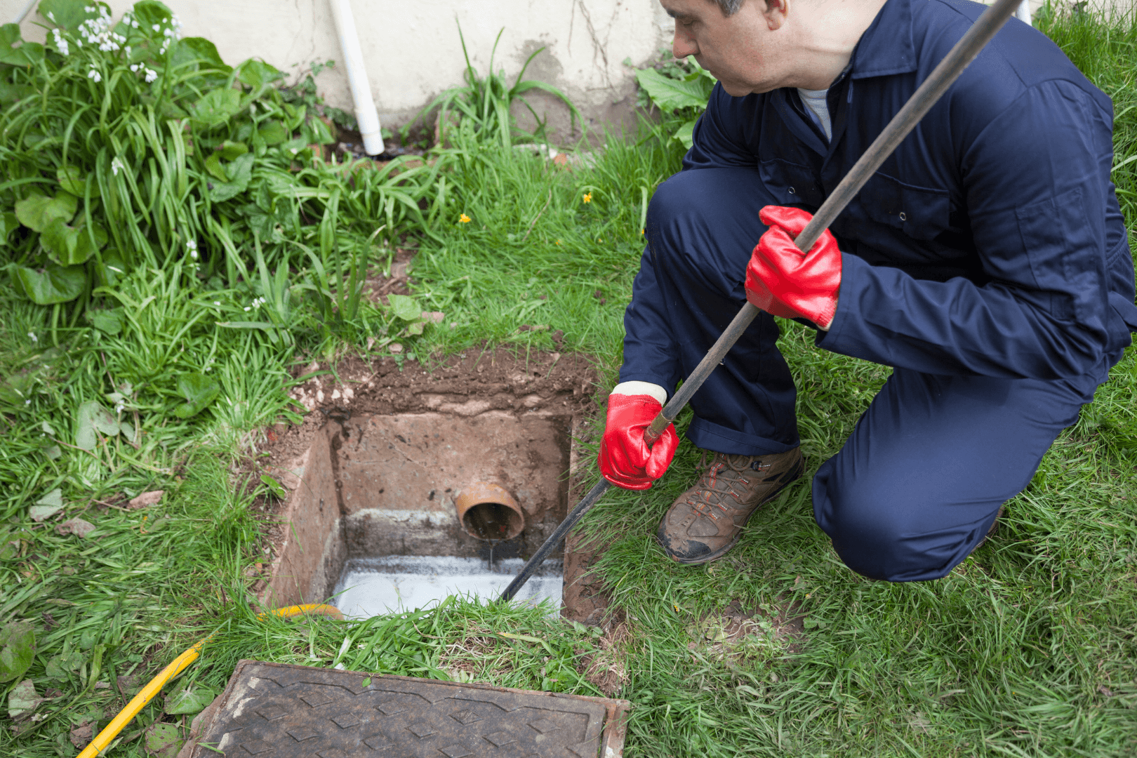 man working with drain pipe